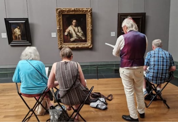 Four artists make drawings from observation of portraits in a gallery