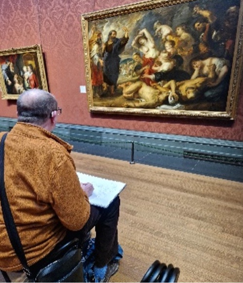 An artist observes and sketches a painting in a gallery.